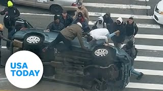 Good Samaritans New York City rush to help stuck driver flipped car | USA TODAY