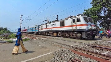 Dangerous situation at Rail Gate careless Women crossing rail line casually front of Duronto Express