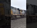 2 big fast CSX trains meet with horns blowing.