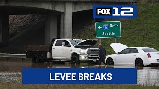 Crews use sandbags to shore up levee breach near Seattle after failure prompts flood warning