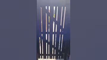Side of house glow-up using a Dizzy Duck Designs patio stencil and black masonry paint.