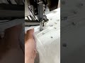 sewing shiny crystal beads on white pleated fabric with an automatic industrial garment machine