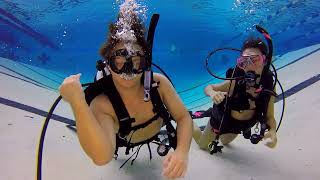 Young Couple Learns To Scuba Dive In Pool