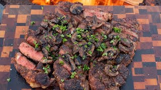 New York Strips w/Bourbon Mushrooms | Over the Fire Cooking by Derek Wolf