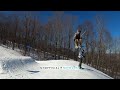 Snowboarder nearly misses skier in landing