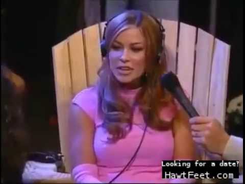 Carmen Electra gets her feet strapped into a chair and then tickled by seve...