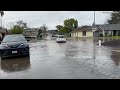 Cars Drive Through Flooded Neighborhood in Antelope