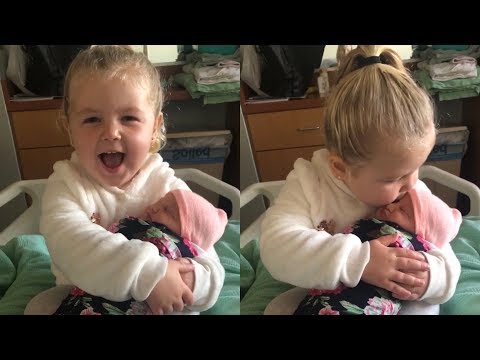 Heartwarming moment 3-year-old girl meets her baby sister for the first time