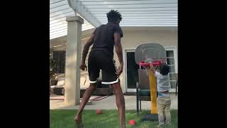 Dad Teaches Toddler 360 Dunk in Backyard - 1147003