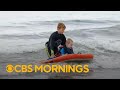 Young surfer teaches others to surf in California