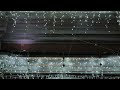 City building decorated with glowing Christmas string lights in winter night