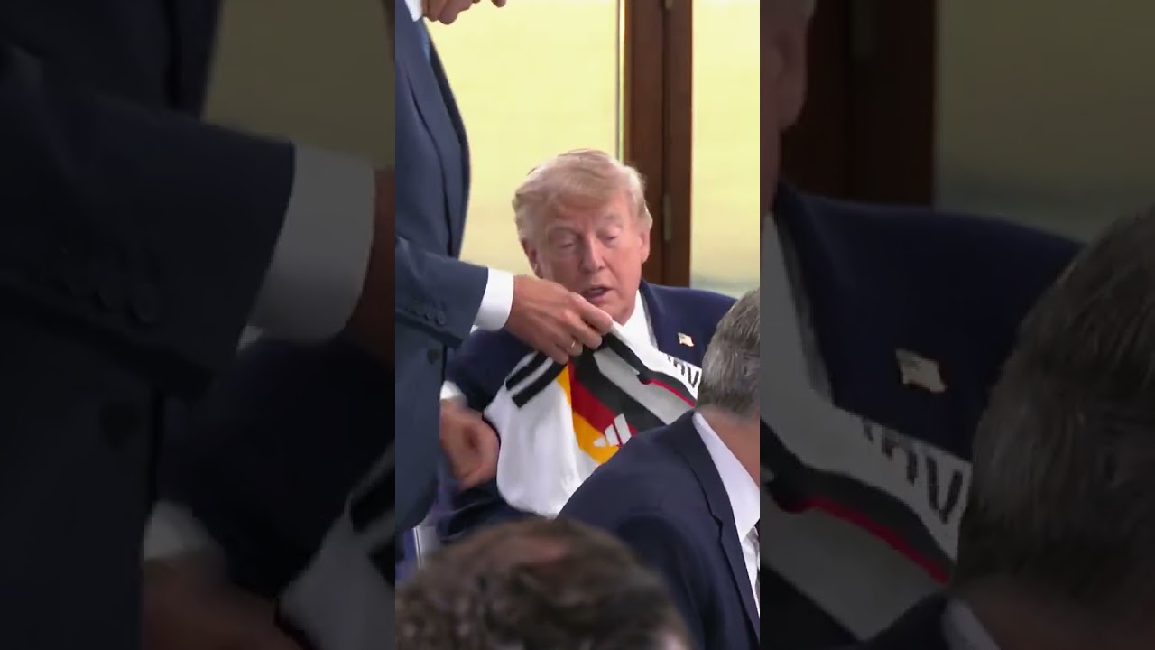 German Chancellor Merz gifts Trump a German football Jersey printed 47 at the G7 Summit in France.