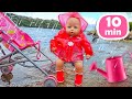 Baby Annabell doll goes for a walk. A new raincoat for the baby born doll. Baby doll feeding time.