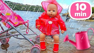 Baby Annabell doll goes for a walk. A new raincoat for the baby born doll. Baby doll feeding time.