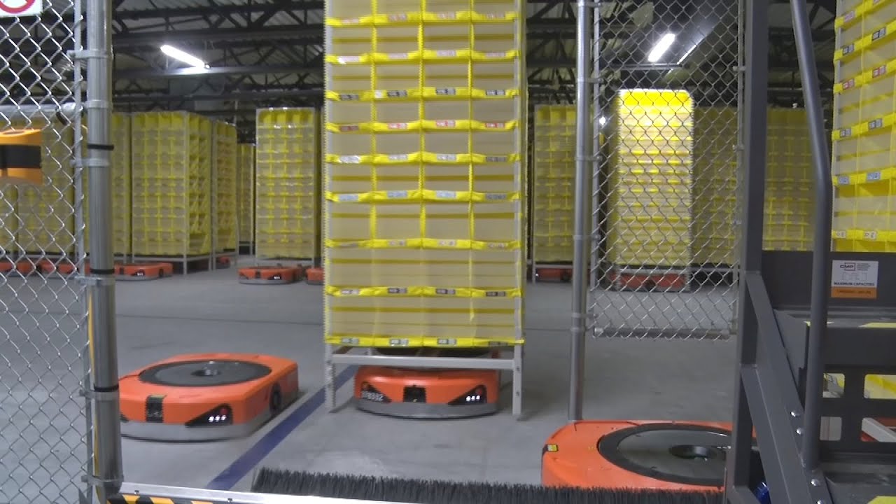Robots assemble your packages at new Amazon center - YouTube