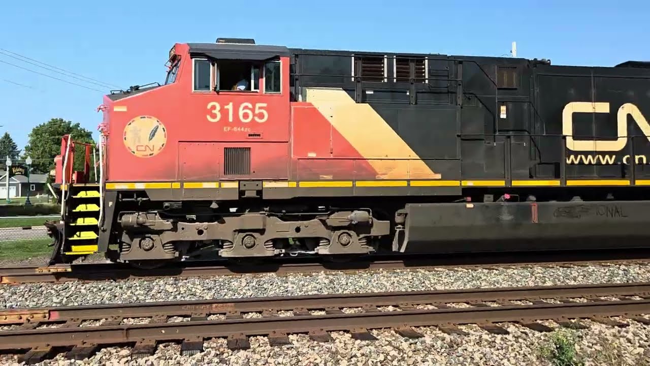 CN 3165, 3206 Westbound train of hoppers, tank cars, covered coil cars with 2 UP covered hoppers