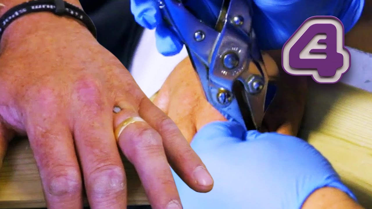 Nail Guns Hand to Plank of Wood Uses Pliers to Get it Out Bizarre