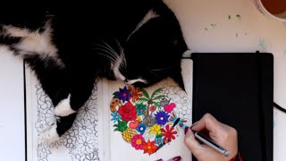 Drawing heart shape doodles in my sketchbook, with help from my cat 😹