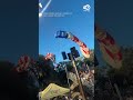 Skydiver carrying American flag crashes into stands
