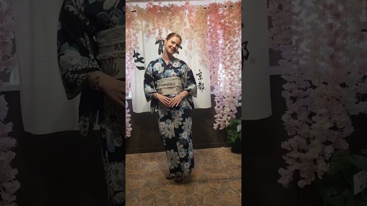 The bold floral pattern and elegant obi pairing create a stylish