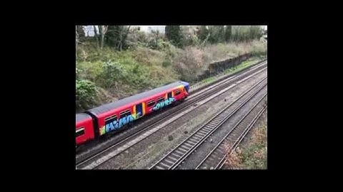 London graffiti train in traffic