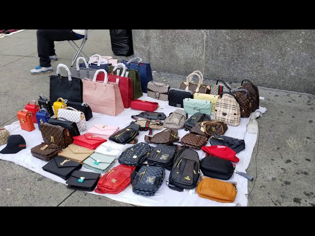 Street vendors on Canal Street selling imitation designer bags in