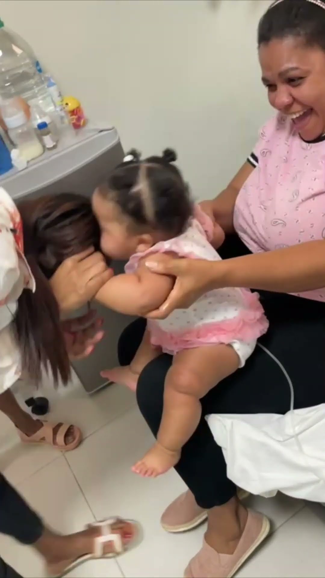 Baby Reaches Out and Playfully Tries to Bite a Family Member's Kiss