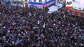 Crowd holds huge pencil aloft Charlie Hebdo workers and families of those killed