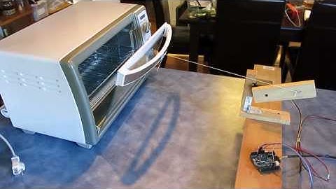 Toaster oven door opener using a servo