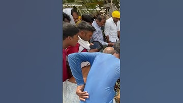 Young man helps Indians catch snakes