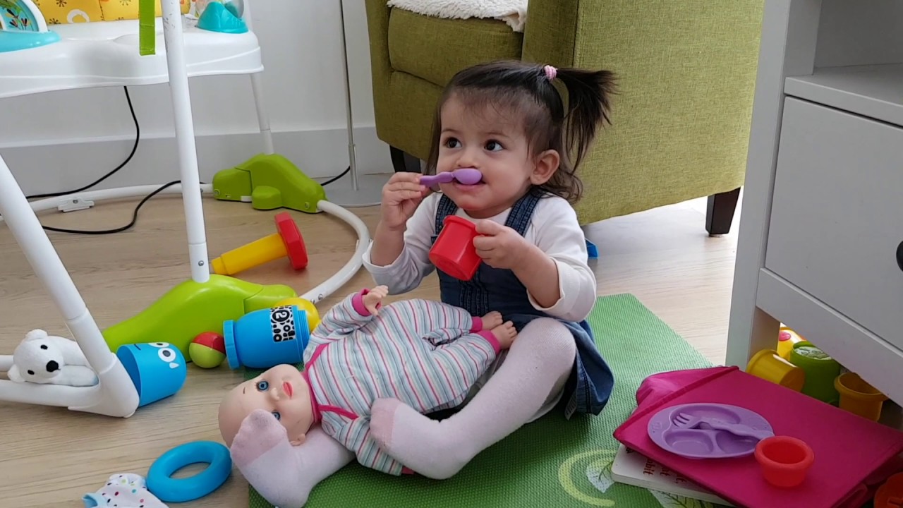 Cute Little Girl Playing with Baby Doll