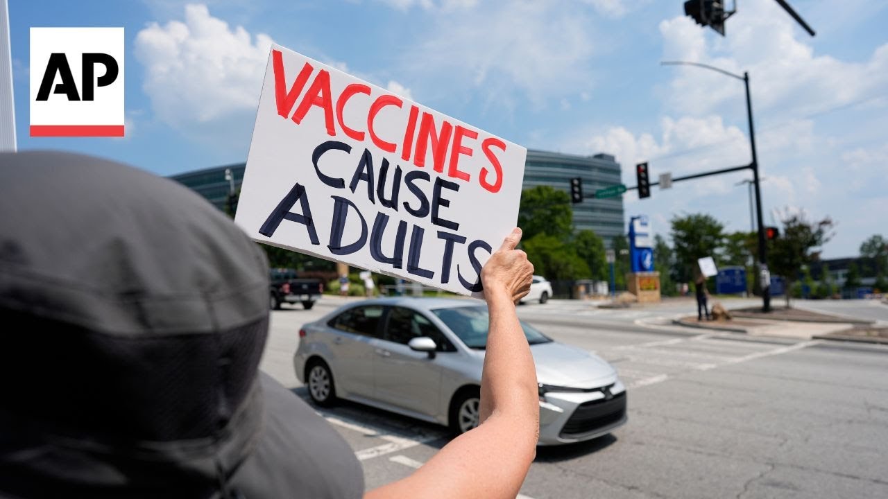 People rally outside of CDC headquarters during vaccine meeting