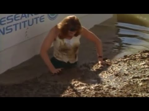 Woman jumps in mud 
