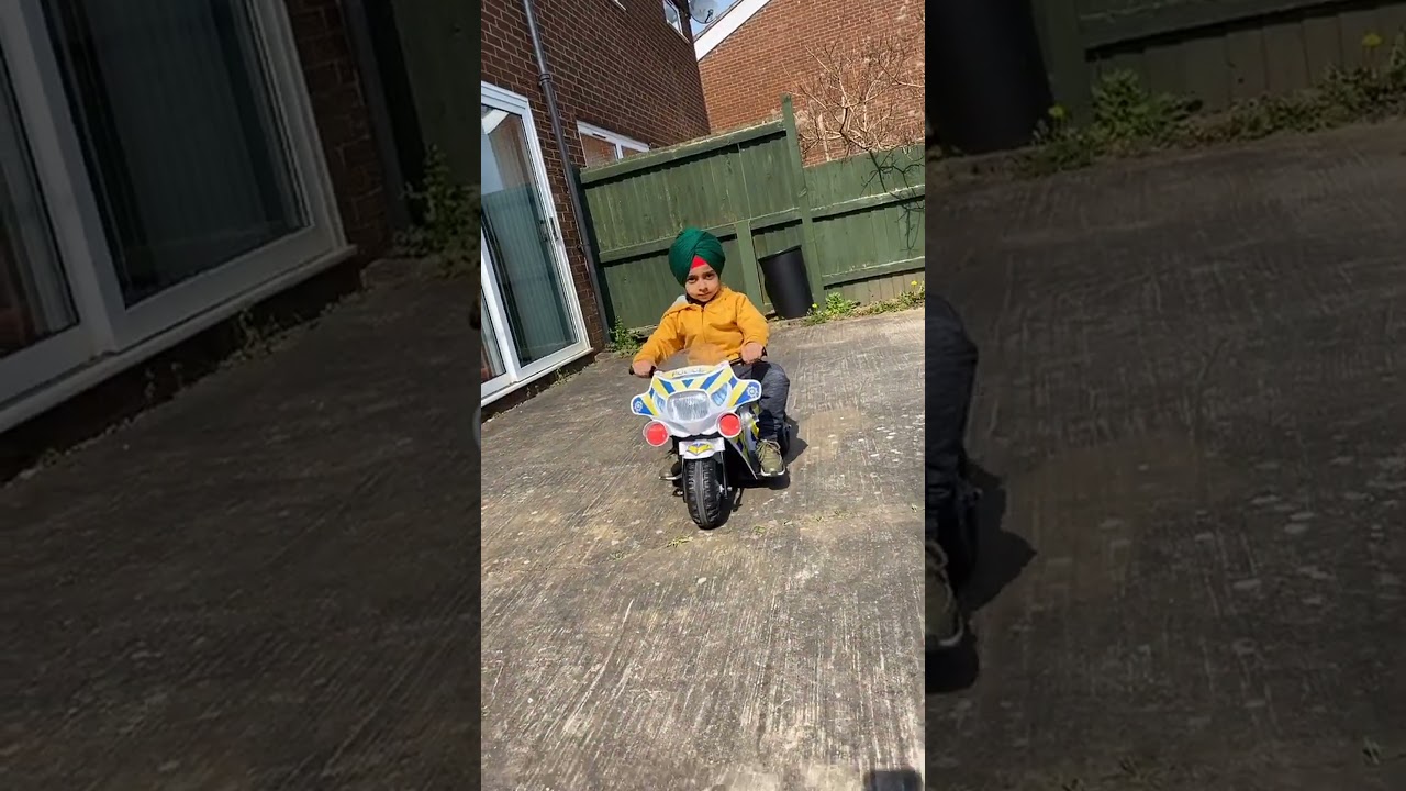 Boy's Backyard Adventure: Riding a Toy Police Motorcycle