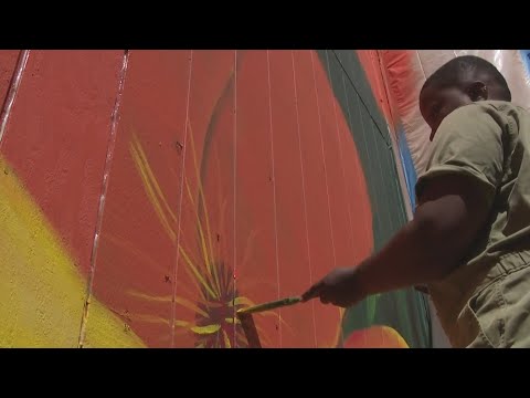 Muralist making her