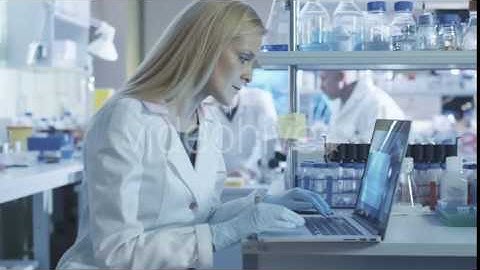 Scientist is Using a Laptop while Working in a Laboratory - Stock Footage | VideoHive 14136435