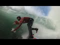 Attempting to paddle into huge waves at Nazare