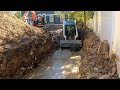 Bobcat T66 working in muddy trench