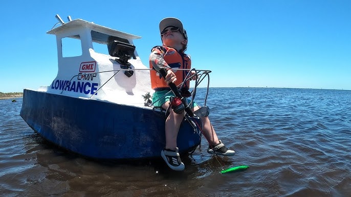 Two year old drives his own mini petrol powered speed boat. 