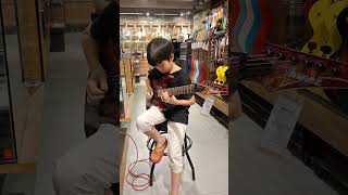 #guitar Redd (10 yo) was playing his new favorite Guitar Ibanez RGB470PB at Swee Lee Music Store PI