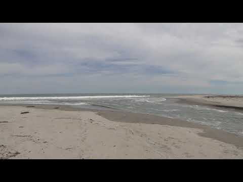 Arm of the sea, receding ocean and this mixture in a river in the middle of two strips of sand