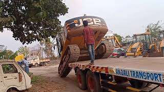 Excavator loading on trailer.