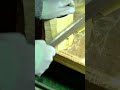 shaping bamboo wood with a sharp large knife for traditional handcrafting on a wooden workbench