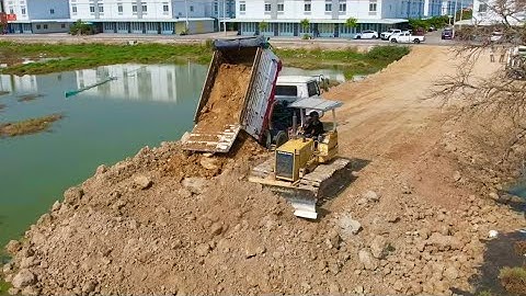 Incredible!! Building new road construction in village is complete by skills dozer spreading soil.