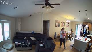 Baby girl stands on chair near dining room table then falls and hits top of head (Security camera)