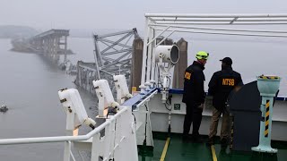 Recovery crews clearing metal debris from the site of the bridge collapse