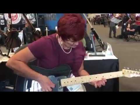 Paula Jo Taylor "Viral Granny Guitarist" playing at a booth at 2017 NAMM Nashville