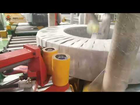 Automatic coil wrapping machine with side tape applicator