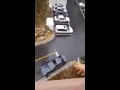 Wife throws lunch from the balcony into the car of her husband