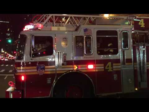 FDNY LADDER 4 RESPONDING FROM QUARTERS ON 8TH AVENUE IN MIDTOWN AREA OF MANHATTAN IN NEW YORK CITY.